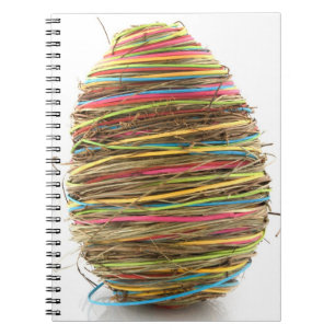 Coloured Straw Easter Eggs Over White Notebook