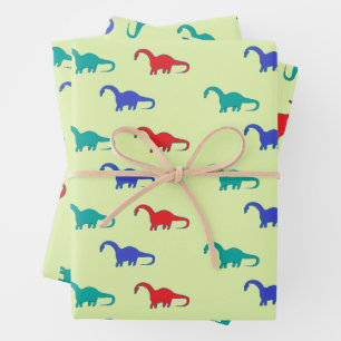 Colourful dinosaurs pattern on green wrapping paper sheet