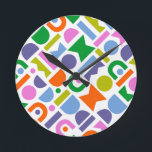 Colourful Geometric Shapes Round Clock<br><div class="desc">A colourful and modern design that features geometric cut-out shapes. This playful design is inspired by retro, mid-century modern style and would be great for the modern home, rec room, playroom or kid’s room. Colours included in this abstract pattern are; blue, purple, pink, green, yellow, pink and orange against a...</div>