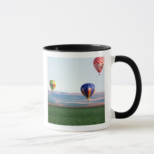 Colourful hot air balloons float over wheat mug (Right)
