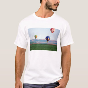 Colourful hot air balloons float over wheat T-Shirt