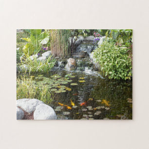 Colourful Koi in Lily pond with waterfall Jigsaw Puzzle