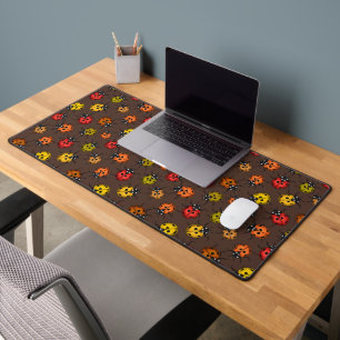Colourful ladybugs on brown desk mat