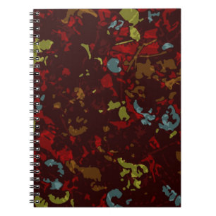 Colourful leaves and flowers against camouflage notebook