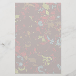 Colourful leaves and flowers against camouflage stationery