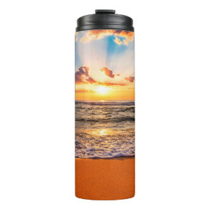 Colourful ocean beach sunrise with deep blue sky a thermal tumbler