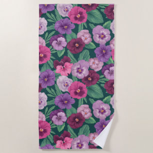 Colourful pansies on dark greenish blue beach towel