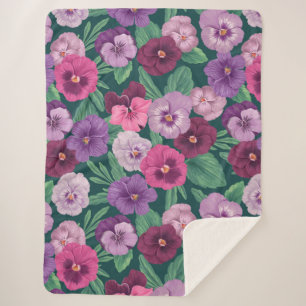 Colourful pansies on dark greenish blue sherpa blanket