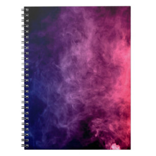 Colourful purple and blue smoke clouds on dark bac notebook