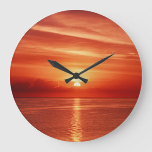 Colourful sunrise at sea, dramatic clouds. large clock