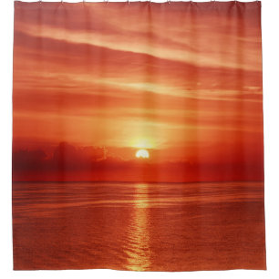 Colourful sunrise at sea, dramatic clouds. shower curtain