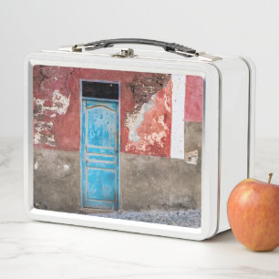 Colourful wall with blue door metal lunch box