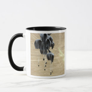 Container delivery system bundles parachute mug