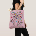 Coquette Bow Christmas Lights Tote Bag<br><div class="desc">A Cute coquette bow with a string of Christmas lights on a dusty pink background. A unique modern glam meets the holidays aesthetic.</div>