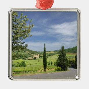 Country road curving between cypress trees in metal ornament