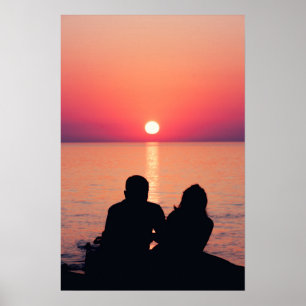 Couple at sea in sunset poster