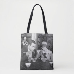 Couple sharing a noodle in a restaurantvintage, fo tote bag