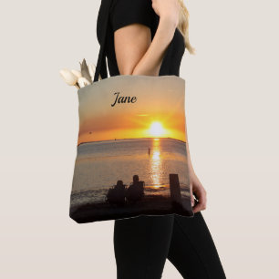 Couple Sit On Beach At Sunset Tote Bag