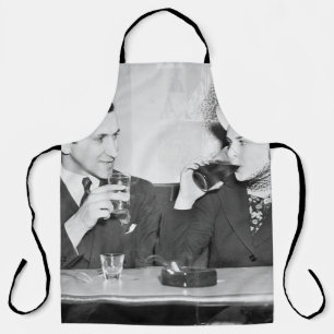Couple sitting together in a restaurant flirting w apron
