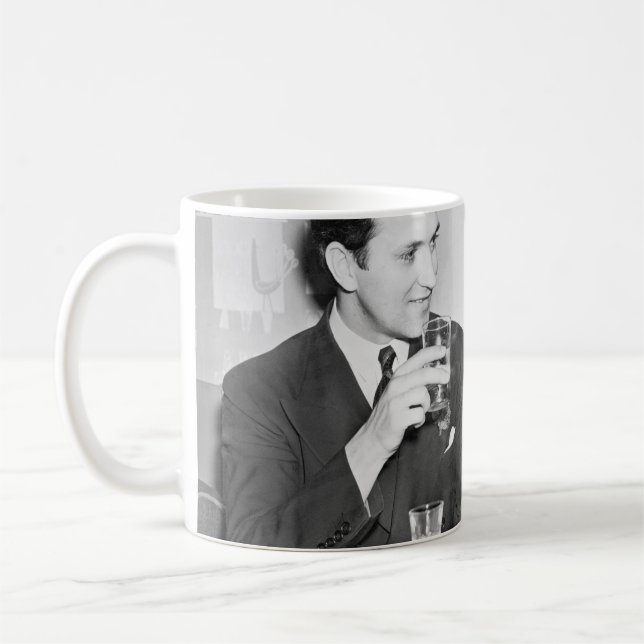 Couple sitting together in a restaurant flirting w coffee mug (Left)