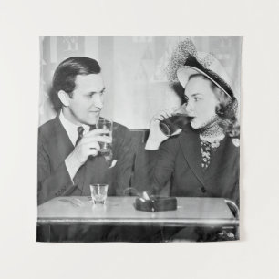 Couple sitting together in a restaurant flirting w tapestry