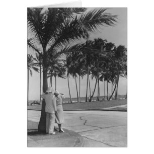 Couple standing at palm tree Rear view B&W