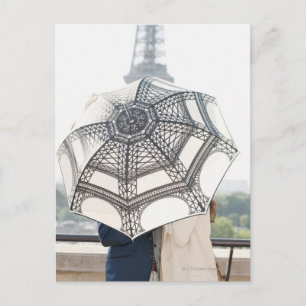 Couple under an umbrella with the Eiffel Tower Postcard