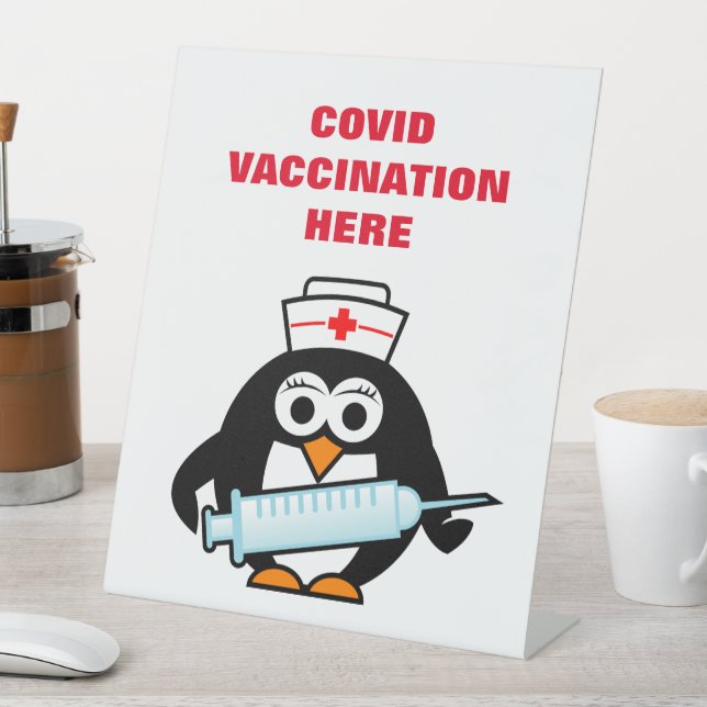 Covid vaccination counter desk sign with cartoon (In SItu)