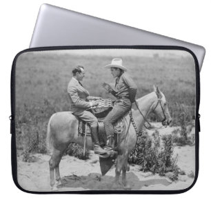 Cowboy and businessman playing checkers on horseba laptop sleeve