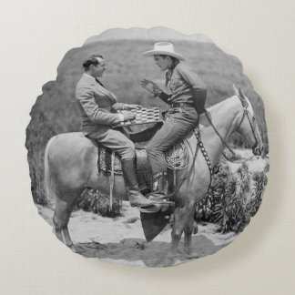 Cowboy and businessman playing checkers on horseba round cushion