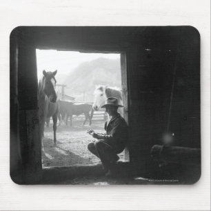 Cowboy in a doorway with horses mouse pad