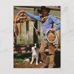 Cowboy posing with lasso and pet dog postcard