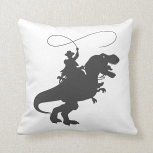 Cowboy riding dinosaur in the prehistoric era cushion