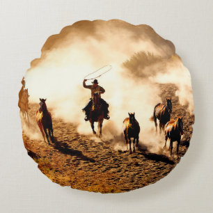 Cowboys chasing wilding horses. roping and riding, round cushion