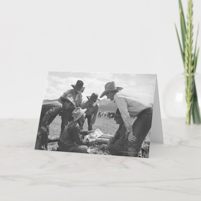 Cowboys looking a magazine card (Front)