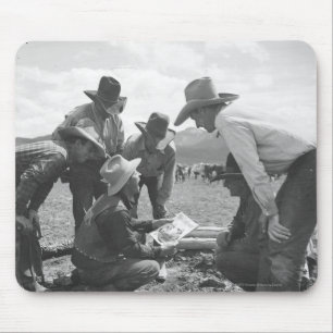 Cowboys looking a magazine mouse pad
