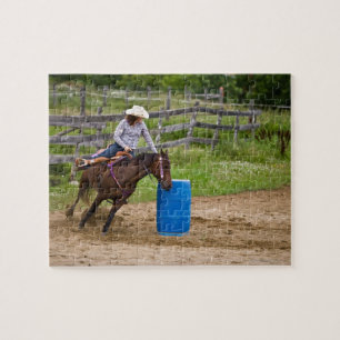 Cowgirl on horseback practicing barrel racing in jigsaw puzzle