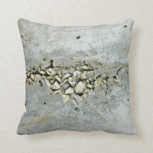Cracked concrete wall with small stones cushion