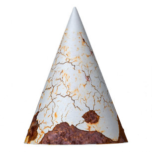 Cracked white paint, rusty car. party hat