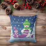 Crafty Snowman Knitting Scarf Cushion<br><div class="desc">Vector illustration of two adorable cartoon snowmen dressed in knitted hats and scarves. The big crafty snowman is knitting an oversized scarf for the little one. The scarf is already wrapped several times around the cute little snowman.</div>