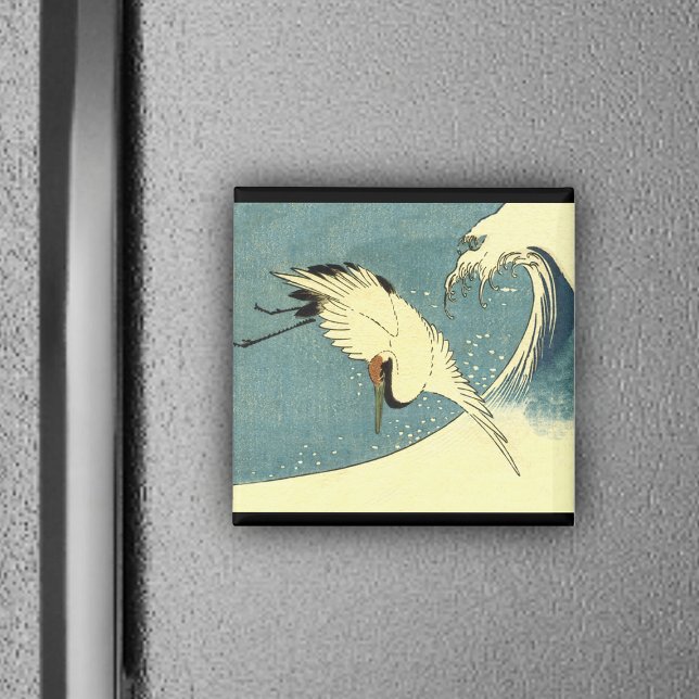 Crane Flying in a Wave Magnet (White crane bird flying over blue ocean wave black borders on magnet.)