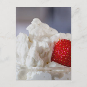 Cream with strawberries in a glass bowl postcard