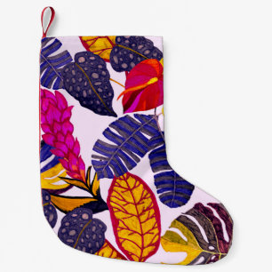Creative seamless pattern with tropical leaves and small christmas stocking