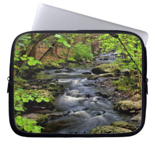 Creek flows through forest laptop sleeve