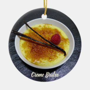 Creme brulee on slate with raspberry and vanilla ceramic ornament
