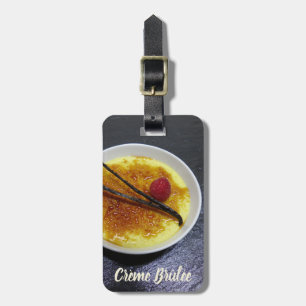 Creme brulee on slate with raspberry and vanilla luggage tag