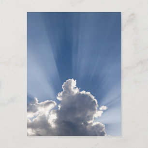 Crepuscular or God's rays streak past cloud. Postcard