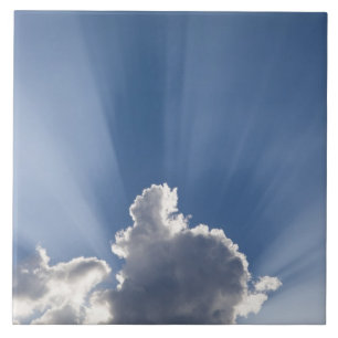 Crepuscular or God's rays streak past cloud. Tile