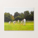 CRICKET JIGSAW PUZZLE<br><div class="desc">A simple art design of a Sunday afternoon village cricket match.</div>