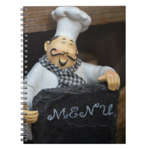 Culinary Delights Await: Chef with Menu Notebook